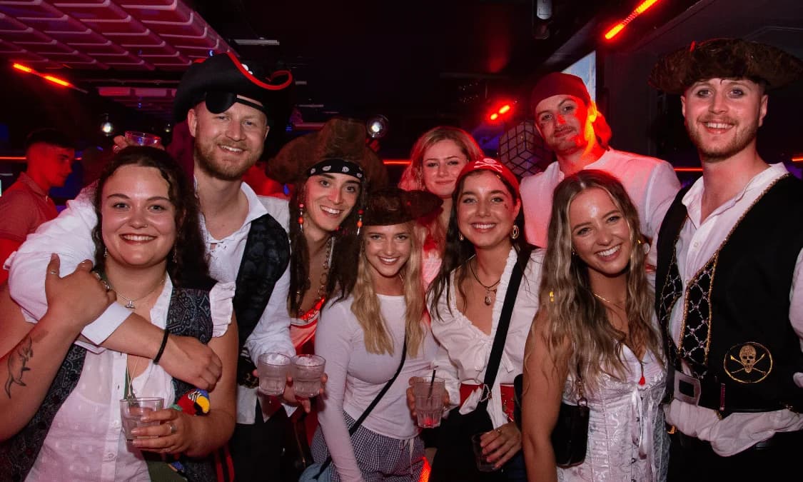 Bar team serving neon cocktails